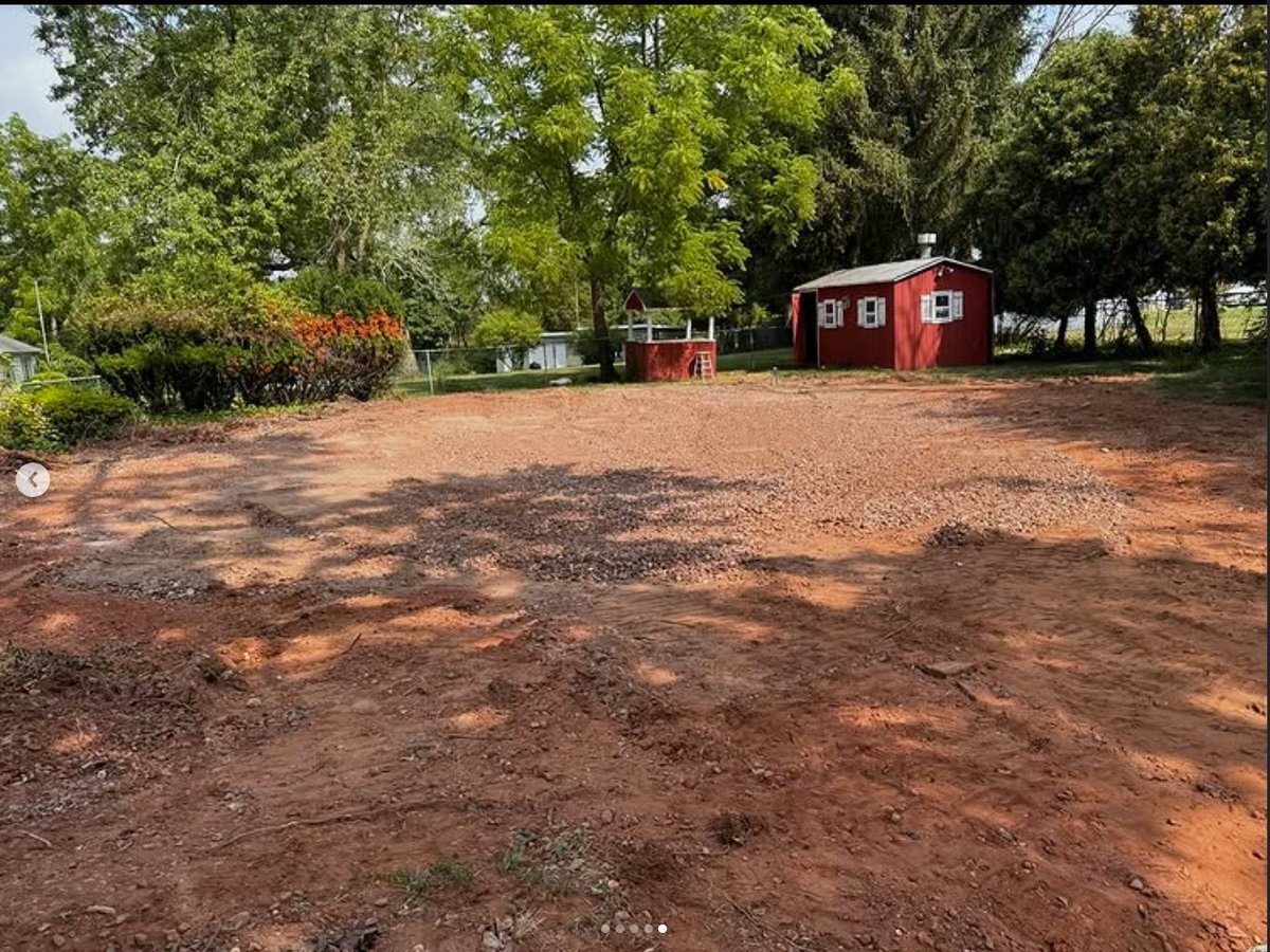 After — graded smooth and hardscape-ready for pavers and an outdoor kitchen
