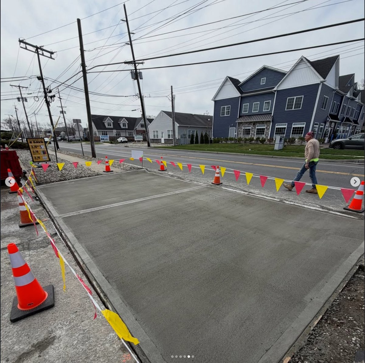 Fresh slab — the new apron poured, finished, and curing behind the barrier