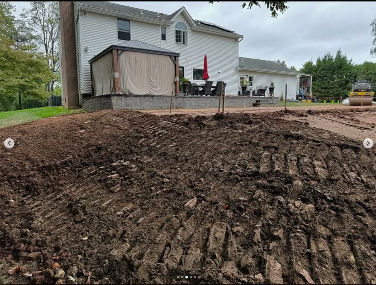 Dirt work in the rain — rough grading and compaction underway