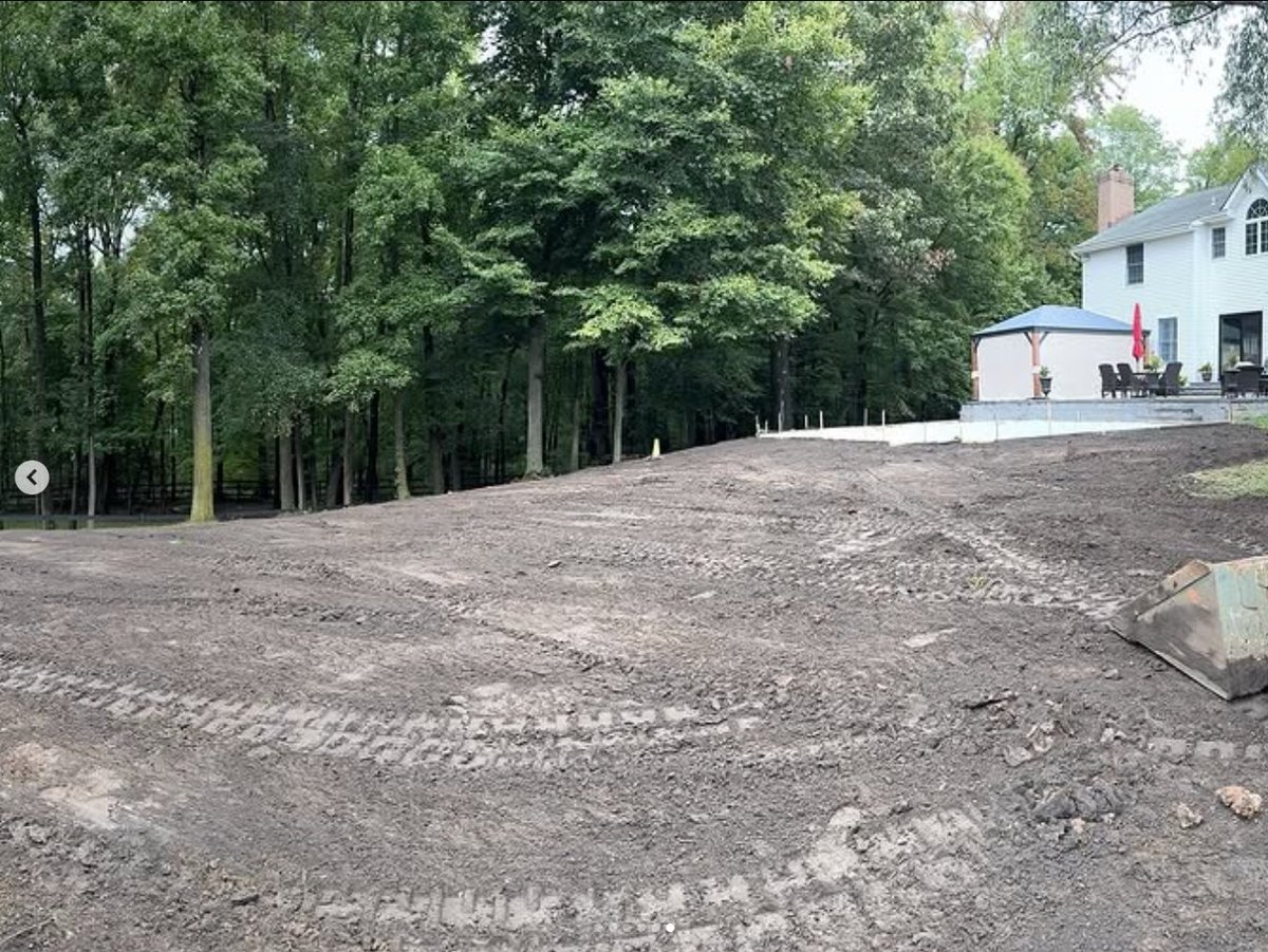 Regraded, level backyard in Millstone, NJ after clean fill and grading